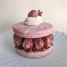 there is a pink cake with icing on it