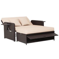 an outdoor chaise lounge chair with pillows and coffee table underneath it, on a white background