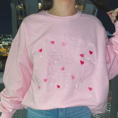 This baby pink or sand crewneck will have your sorority spelled out in a full front embroidered design surrounded with hearts (& love!), just pick your size, color and sorority and we will take care of the rest! <3 ***Due to nationwide stock shortages, we have several different manufacturers for our pink crews. The color, weight, and specs are similar on all of them. *Model is wearing a size XL for an oversized fit Size Chart: Pink Sorority Letters Sweatshirt, Sorority Crewneck Designs, Sorority Embroidery, Rush Sorority, Sorority Clothing, Embroidered Sorority Sweatshirts, Sorority Crewneck, Pink Sorority, Sorority Embroidered Sweatshirt