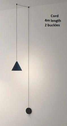 three lights hanging from the ceiling in a room with white walls and black flooring