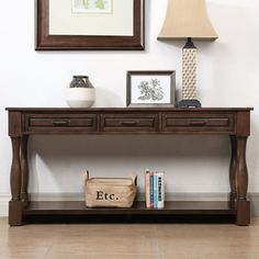 a wooden table with two drawers underneath a lamp