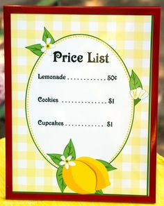 a price list with lemons and flowers on the front, sitting on top of a table