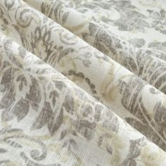 an upholstered fabric with floral designs on the outside, in beige and white