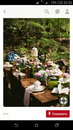 an image of a table set with flowers and cake