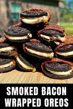 a pile of bacon wrapped oreos sitting on top of a wooden table next to a red and white sign