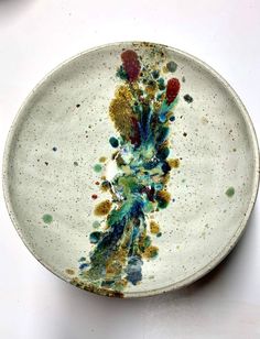 a white plate with multicolored flowers on it