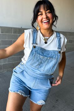 Overalls alert! ☀️ These medium-wash denim cuties are ready for all-day fun. The relaxed fit keeps things comfy and cool, while the adjustable straps ensure a perfect fit. They've got all the classic details you love: a handy chest pocket, side and back pockets for your essentials, and a trendy frayed hem. Dress them up or down - these overalls are your new summer go-to! Adjustable shoulder straps Chest pocket Relaxed fit short overalls Side and back pockets Frayed hem Medium-wash denim 95% Cotton, 5% Polyester Fit and sizing:  Measurements are approximate. Length measurements are taken from the top of the shoulder to the bottom hem lying flat. Small - Waist: 32", Hip: 38", Inseam: 3" Medium - Waist: 34", Hip: 40", Inseam: 3" Large - Waist: 36", Hip: 42", Inseam: 3" XLarge - ﻿Waist: 38", H Blue Denim Overalls, Overalls Shorts, Denim Overalls Shorts, Short Overalls, 8 Months, Denim Overalls, Hem Dress, Small Waist, Workout Shorts