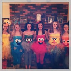 a group of young women standing next to each other wearing costumes made out of paper bags