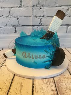 a blue cake with a toothbrush on top and the word ottura written in frosting