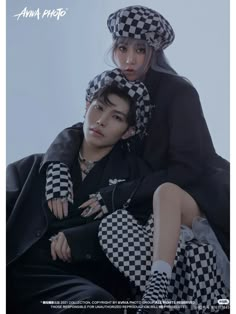 two people sitting on top of each other wearing hats and checkered pants, one person is