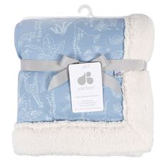 a blue and white blanket with a tag on it that says just born in the middle