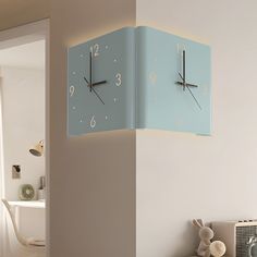 a blue clock hanging from the side of a wall next to a radiator