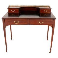 an antique wooden desk with two drawers on one side and a gold trim around the top