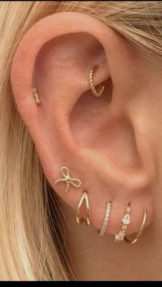 an ear with three different types of piercings on it