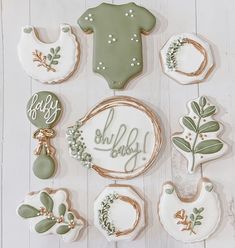 baby shower cookies are arranged in the shape of wreaths and ones with leaves on them