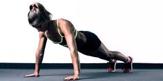 a woman is doing push ups on the floor