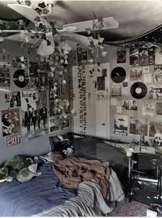 a bed room with a bunch of pictures on the wall