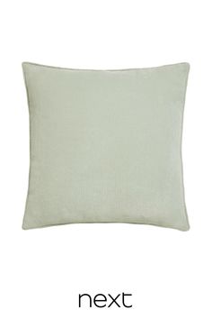 a light green pillow with the text next written in black and white letters on it