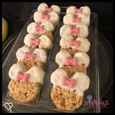 some kind of dessert that is on a glass platter with pink and white icing