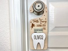 a tooth shaped door hanger on a white door