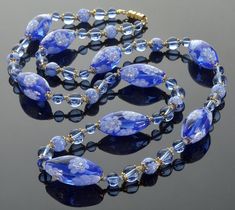 "Vintage Venetian Murano periwinkle blue  glass bead necklace from 1950's The necklace is 30\" long. Hand blown matching canes  translucent glass beads with gilded brass caps, oval  approx. 1\" x 1/2\", round 5/16\". Periwinkle blue beads are 5/16\" and 1/4\". Gilded brass barrel clasp. One oval bead has a small approx. 2mm imperfection from original manufacturing (see last photo). Excellent vintage condition." Necklace Matching, Translucent Glass, Murano Glass Beads, Periwinkle Blue, Glass Bead Necklace, Blue Beads, Glass Bead, Murano Glass, Bead Necklace