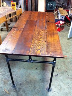 a table made out of wood and pipe legs