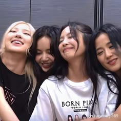 four girls are smiling and posing for the camera