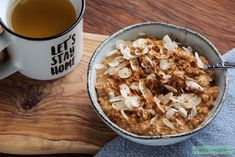 a bowl of oatmeal next to a cup of tea