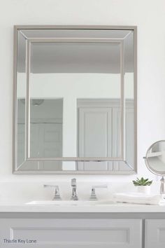 a bathroom sink with a large mirror above it