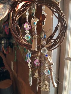 a wind chime hanging from the side of a window with lots of beads on it