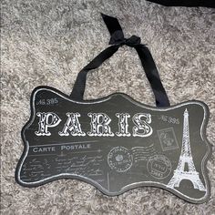 a sign that says paris on it with the eiffel tower in the background