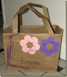 a brown bag with purple flowers and name on it sitting on the floor in front of a door