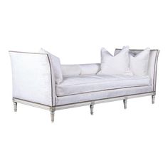 a white couch with pillows on top of it