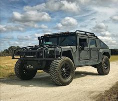 an off road vehicle parked on a dirt road