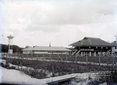 an old black and white photo of a train station in the middle of winter with snow on the ground