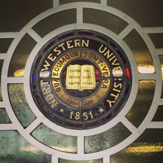 the stained glass window above the door is decorated with gold and black lettering that reads western university