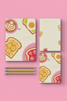 two notebooks with food on them next to pencils