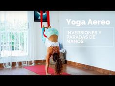 a woman doing a handstand on a yoga mat