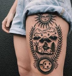 a woman's thigh with an image of the sun and moon on it