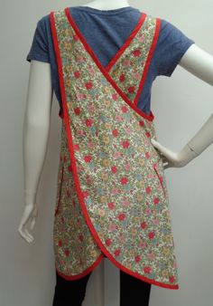 a mannequin wearing a dress with flowers on it and a blue shirt underneath