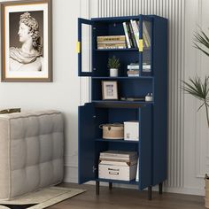 a blue bookcase in a living room next to a couch and potted plant