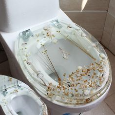 a toilet that has some kind of decoration on the side of it's seat