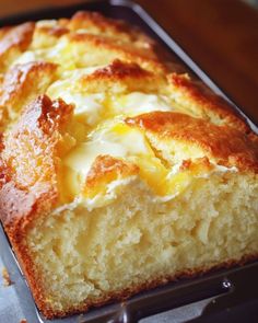 a close up of a loaf of bread on a baking pan with buttery toppings