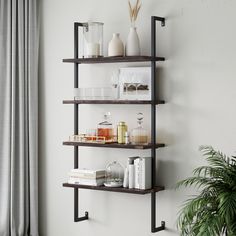 a shelf with books, candles and other items on it