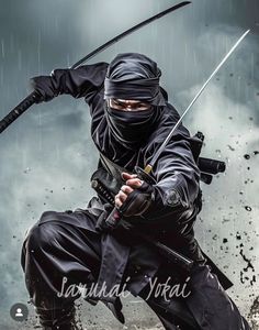 a man dressed in black holding two swords and aiming it at the ground with rain falling on him