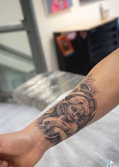 a woman's arm with a tattoo on it and a skull in the middle