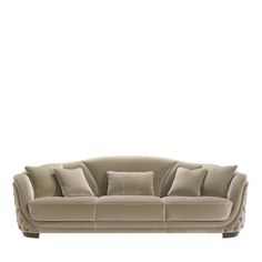 an image of a couch with pillows on the top and bottom half, in beige