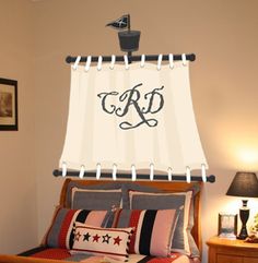 a bedroom with a bed, lamps and pictures on the wall above it that says c & d