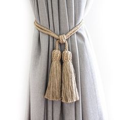 a curtain with two tassels attached to it