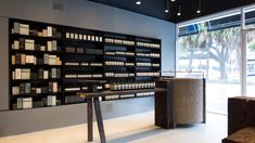 an empty room with bottles on the wall and shelves full of different types of items